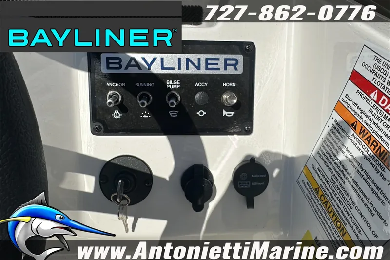 Slide: The Image of Control panel of 2024 Bayliner Element M19 boat with switches and warning labels. - 21