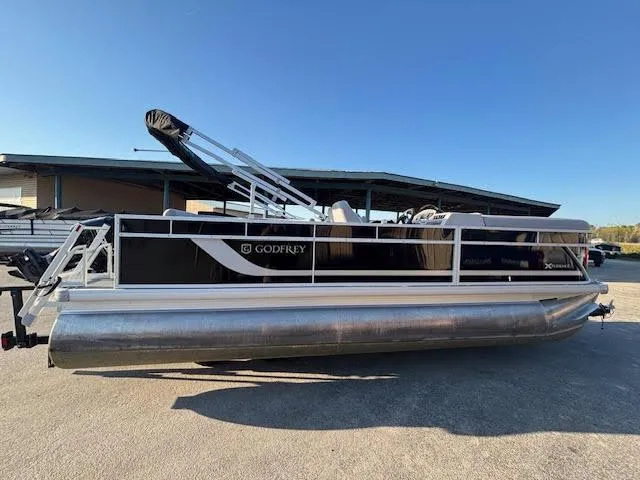 The Image of 2024 Godfrey 2086EX Xperience Cruise pontoon boat, side view, parked outdoors. - 0