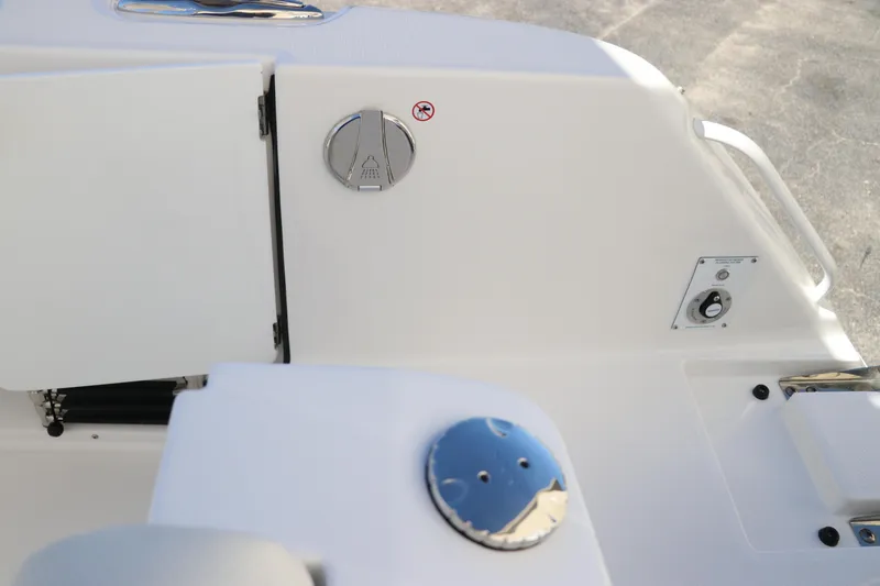 Slide: The Image of 2024 Edgewater 262CX boat interior, featuring storage compartments and control panel. - 13