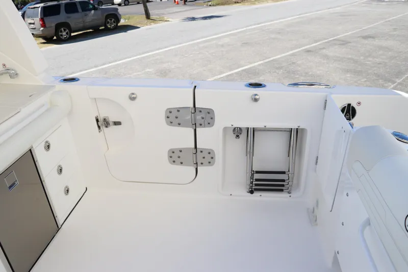 Slide: The Image of 2024 Edgewater 262CX boat interior with storage compartments and ladder. - 15