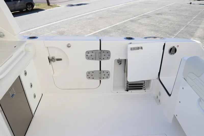 Slide: The Image of 2024 Edgewater 262CX boat interior with storage compartments and access hatches. - 16