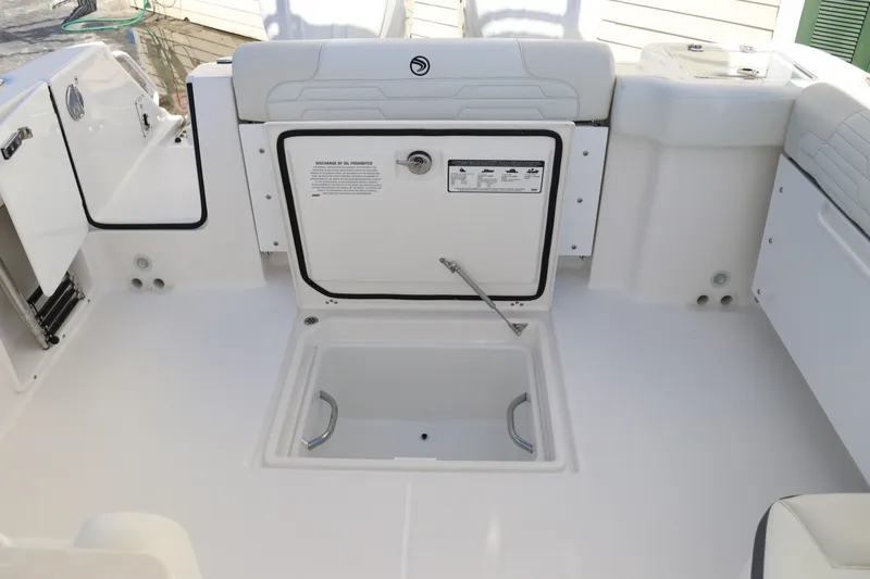 Slide: The Image of 2024 Edgewater 262CX boat deck with storage compartment open. - 18