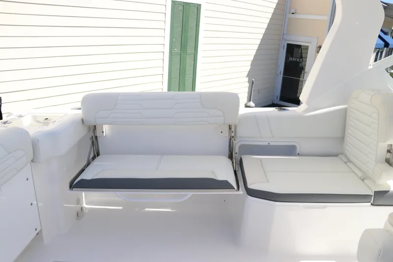 Slide: The Image of 2024 Edgewater 262CX boat interior with white cushioned seating. - 21