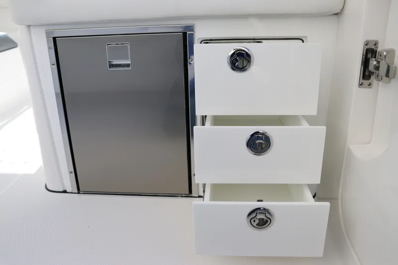 Slide: The Image of 2024 Edgewater 262CX boat storage drawers and stainless steel cabinet. - 25