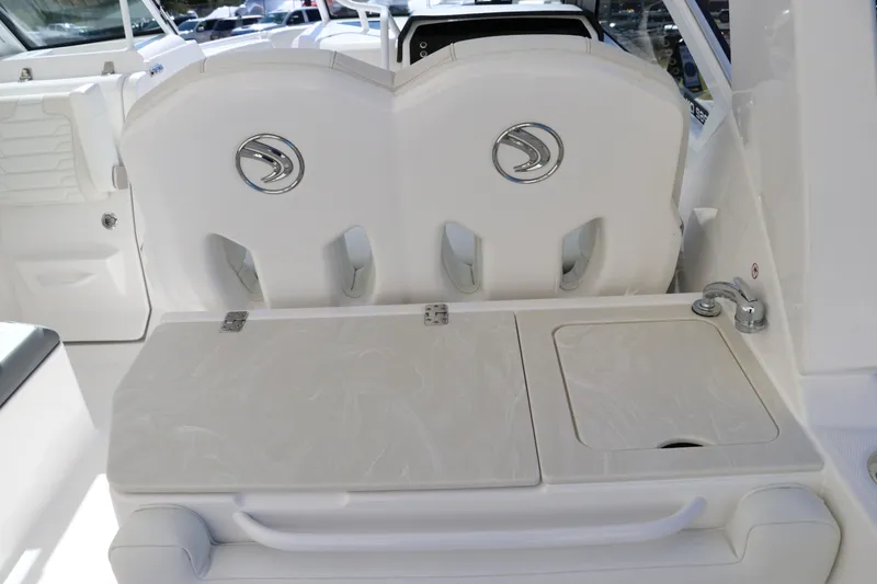 Slide: The Image of 2024 Edgewater 262CX boat interior with dual seats and storage compartments. - 26
