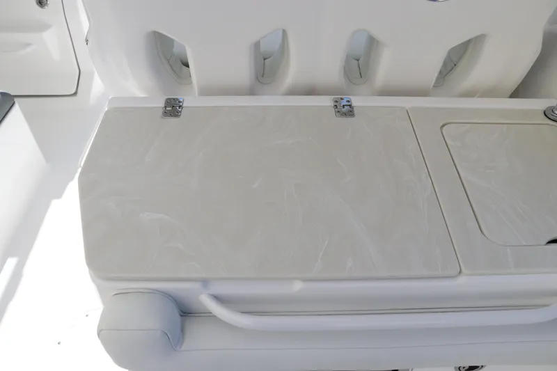 Slide: The Image of 2024 Edgewater 262CX boat interior with white seating and storage compartments. - 29