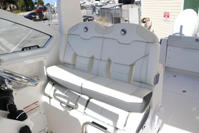 Slide: The Image of 2024 Edgewater 262CX boat interior with white cushioned seating. - 31