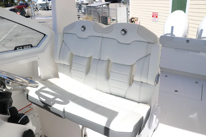 Slide: The Image of 2024 Edgewater 262CX boat interior with white cushioned seating. - 32