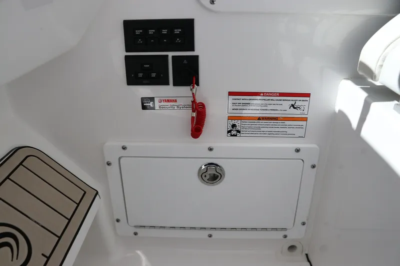 Slide: The Image of 2024 Edgewater 262CX boat control panel and storage compartment. - 34