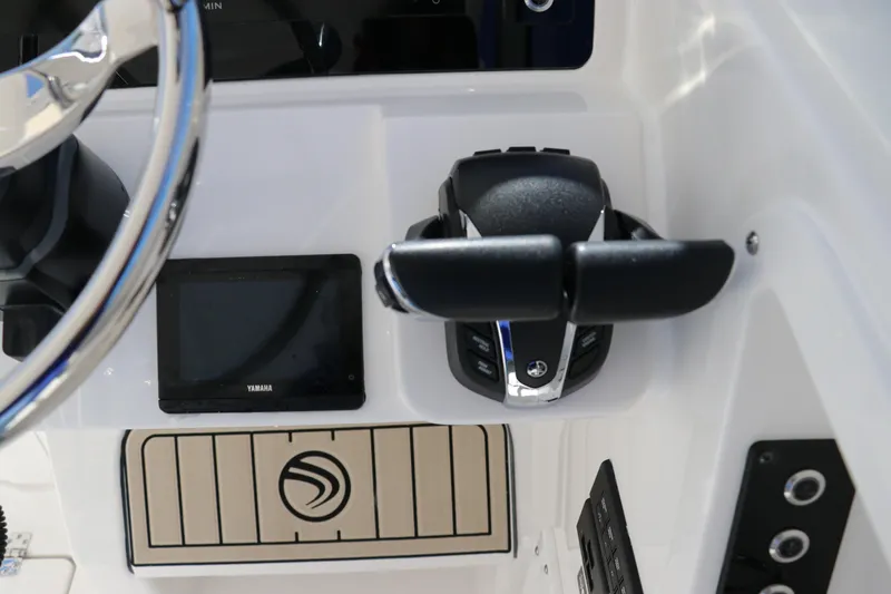 Slide: The Image of Edgewater 262CX 2024 boat control panel with steering wheel and throttle. - 37