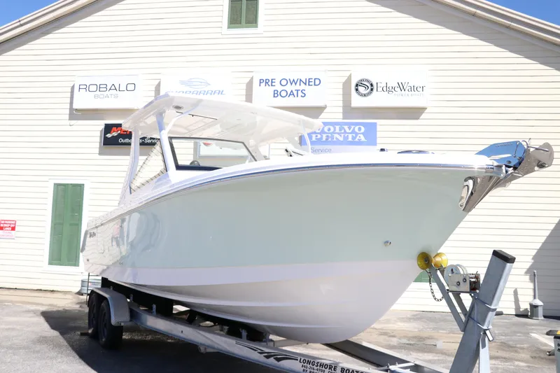 Slide: The Image of 2024 Edgewater 262CX boat on trailer at dealership. - 4