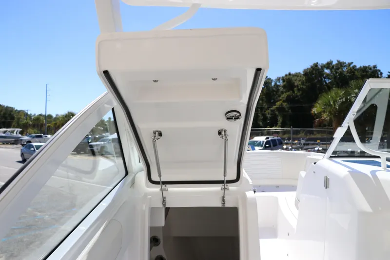 Slide: The Image of 2024 Edgewater 262CX boat with open storage compartment. - 45