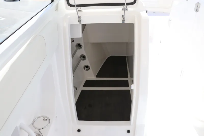 Slide: The Image of 2024 Edgewater 262CX boat storage compartment with open hatch. - 46