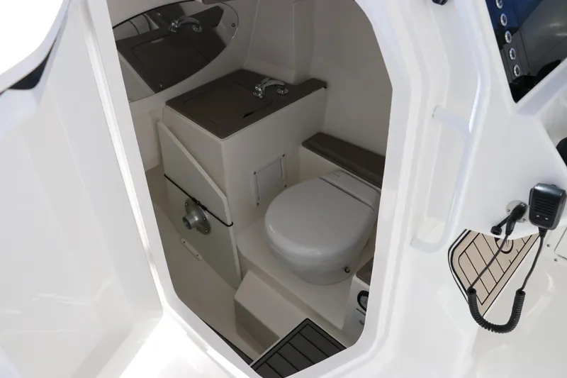 Slide: The Image of 2024 Edgewater 262CX boat interior bathroom with toilet and sink. - 48