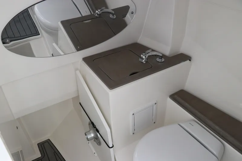 Slide: The Image of 2024 Edgewater 262CX boat interior bathroom with sink and toilet. - 49