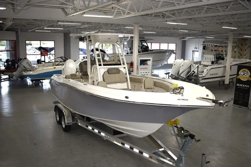 The Image of 2024 Key West 244 CC center console boat on a trailer in a showroom. - 1