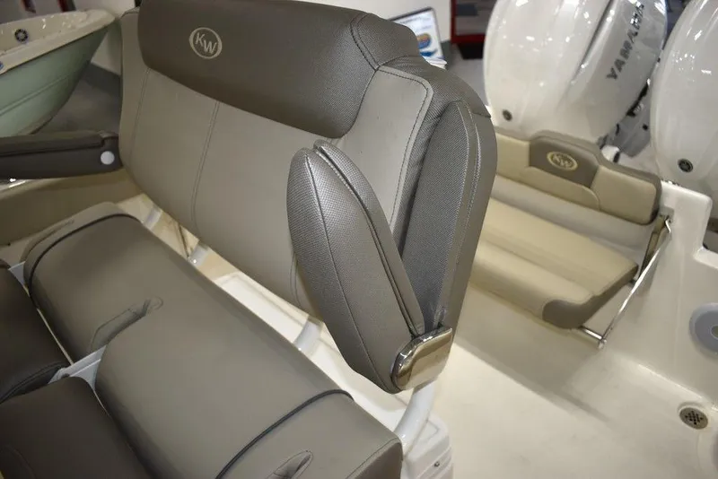 Slide: The Image of 2024 Key West 244 CC boat interior seating with Yamaha engines in background. - 22