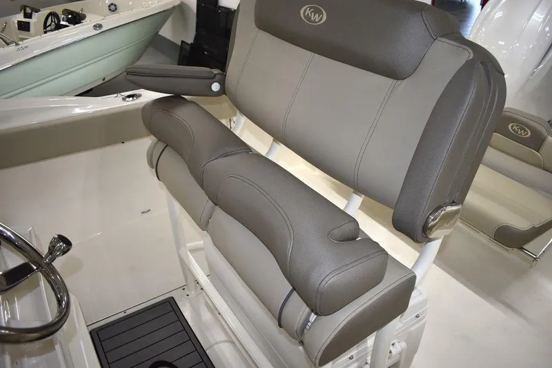 Slide: The Image of 2024 Key West 244 CC boat with cushioned seating and steering wheel. - 23