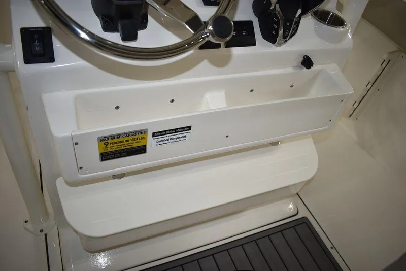 Slide: The Image of 2024 Key West 244 CC boat console with steering wheel and storage compartments. - 25