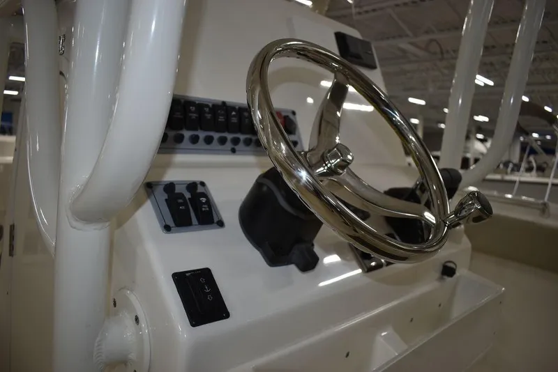 Slide: The Image of 2024 Key West 244 CC boat steering console with stainless steel wheel and control panel. - 27