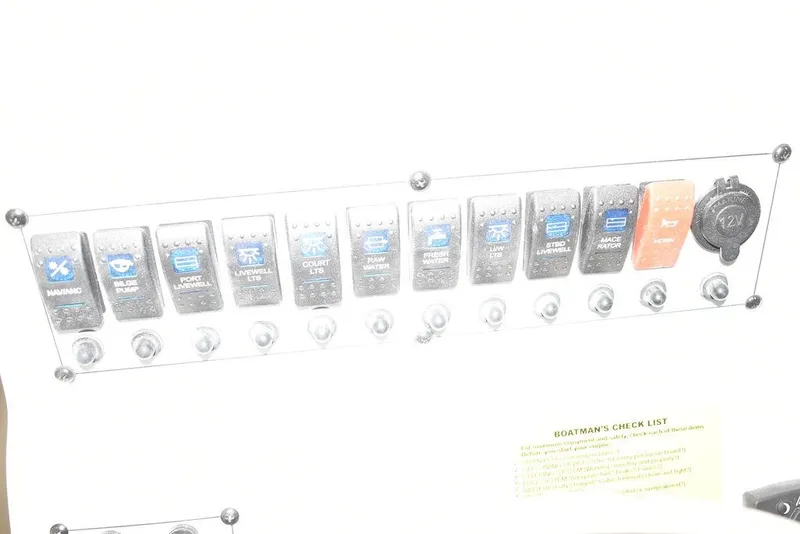 Slide: The Image of Control panel of a 2024 Key West 244 CC boat with labeled switches. - 29