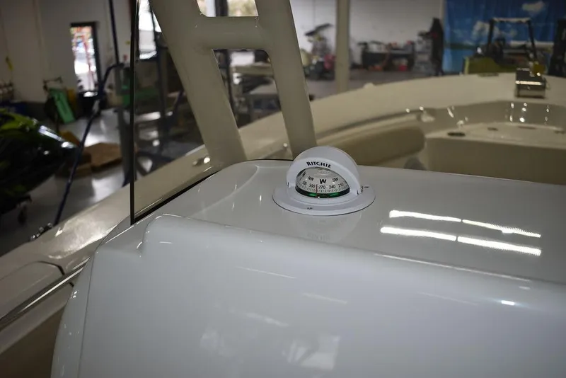 Slide: The Image of 2024 Key West 244 CC boat interior with compass in a workshop. - 35