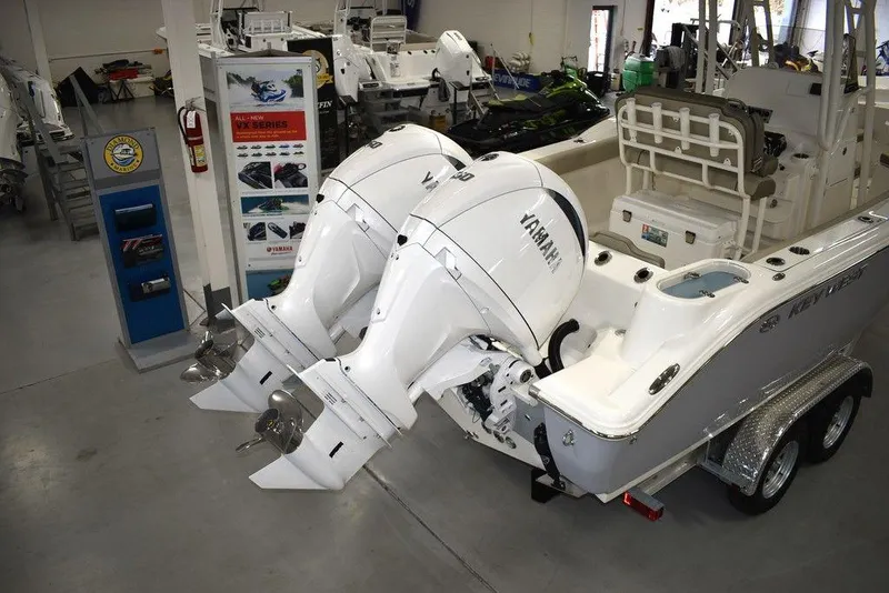 Slide: The Image of 2024 Key West 244 CC boat with twin Yamaha outboard engines in a showroom. - 4