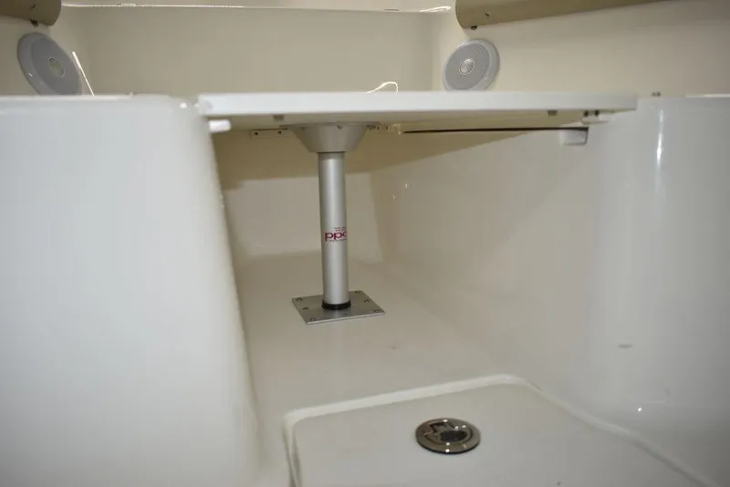 Slide: The Image of 2024 Key West 244 CC boat interior with table and speakers. - 49