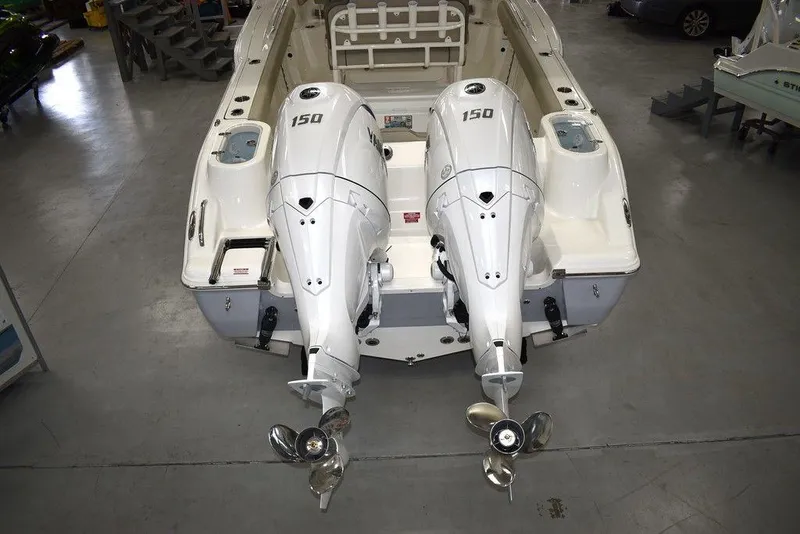 Slide: The Image of 2024 Key West 244 CC boat with twin 150 HP outboard engines in a showroom. - 5