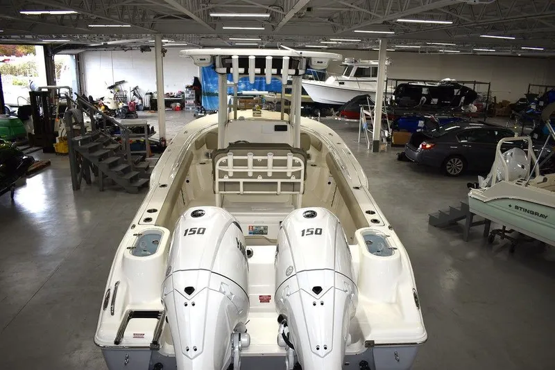 Slide: The Image of 2024 Key West 244 CC boat with twin 150 HP engines in a showroom. - 6