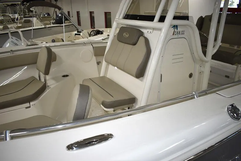Slide: The Image of 2024 Key West 244 CC boat interior with cushioned seating and storage compartments. - 11