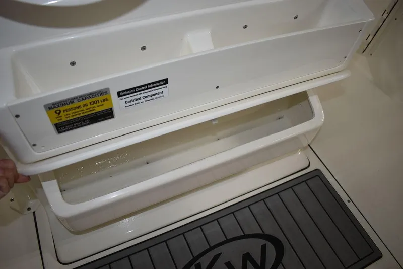 Slide: The Image of Key West 244 CC 2024 boat storage compartments and capacity label. - 26