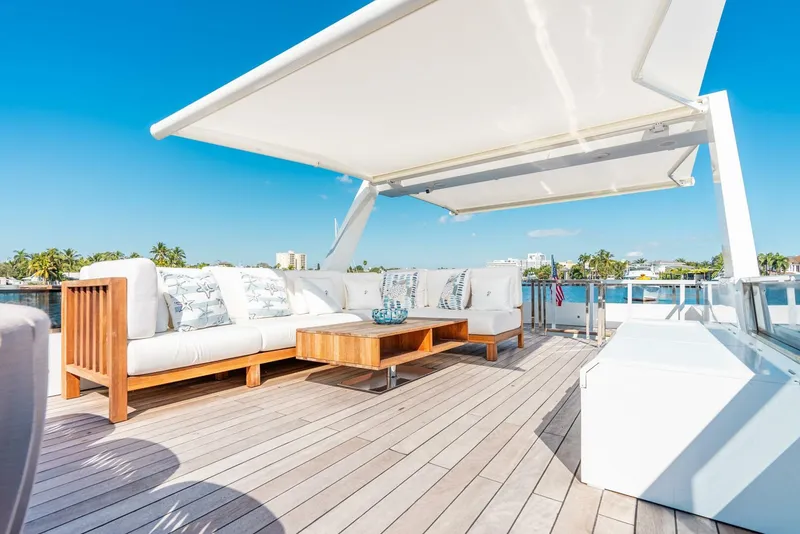 Slide: The Image of Luxury deck of Reina L44 DR yacht, 2024 model, with modern outdoor seating. - 11