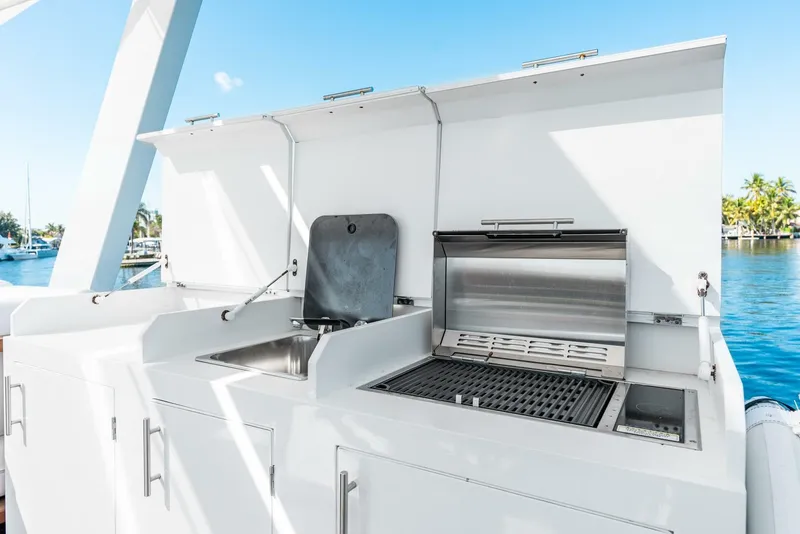 Slide: The Image of Outdoor kitchen on a 2024 Reina L44 DR yacht with grill and sink. - 12