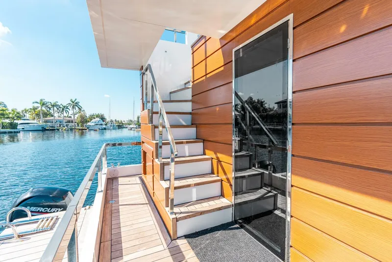 Slide: The Image of 2024 Reina L44 DR yacht with exterior stairs and waterfront view. - 15