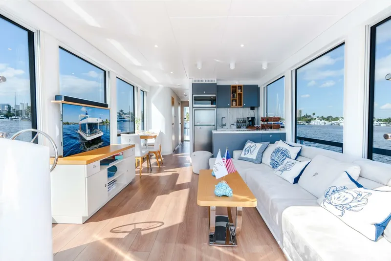 Slide: The Image of Luxurious interior of Reina L44 DR 2024 yacht with modern furnishings and panoramic windows. - 16