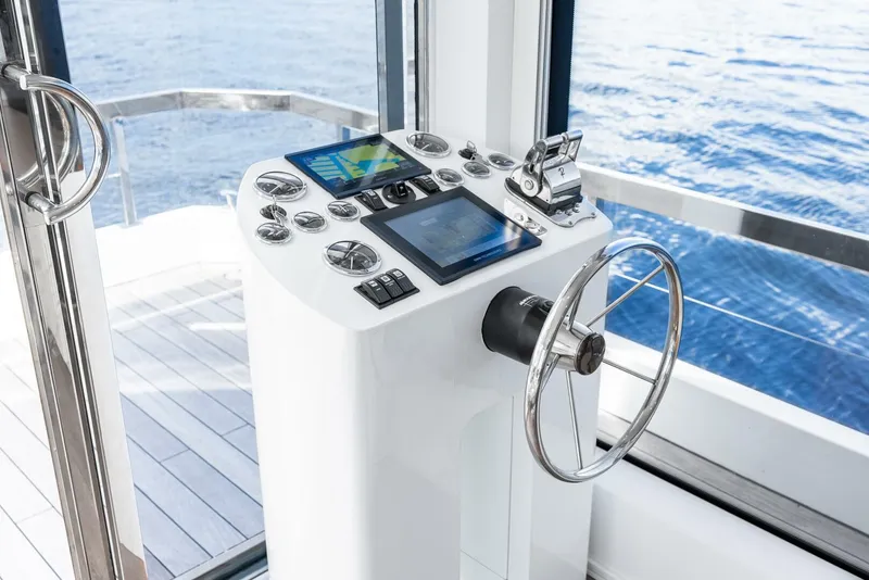 Slide: The Image of 2024 Reina L44 DR yacht helm with modern navigation controls and ocean view. - 21