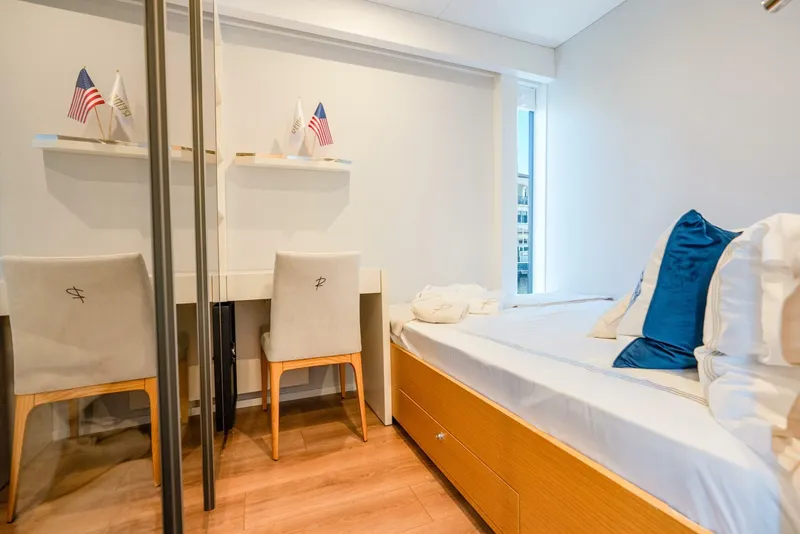 Slide: The Image of Modern compact bedroom with desk, chairs, and bed; Reina L44 DR, 2024 model. - 25