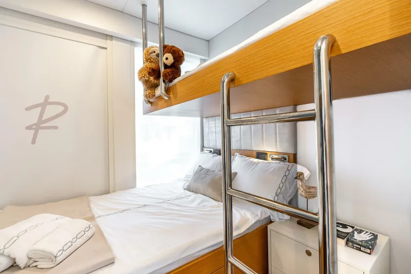 Slide: The Image of Modern Reina L44 DR 2024 RV interior with cozy bunk beds and plush teddy bears. - 27