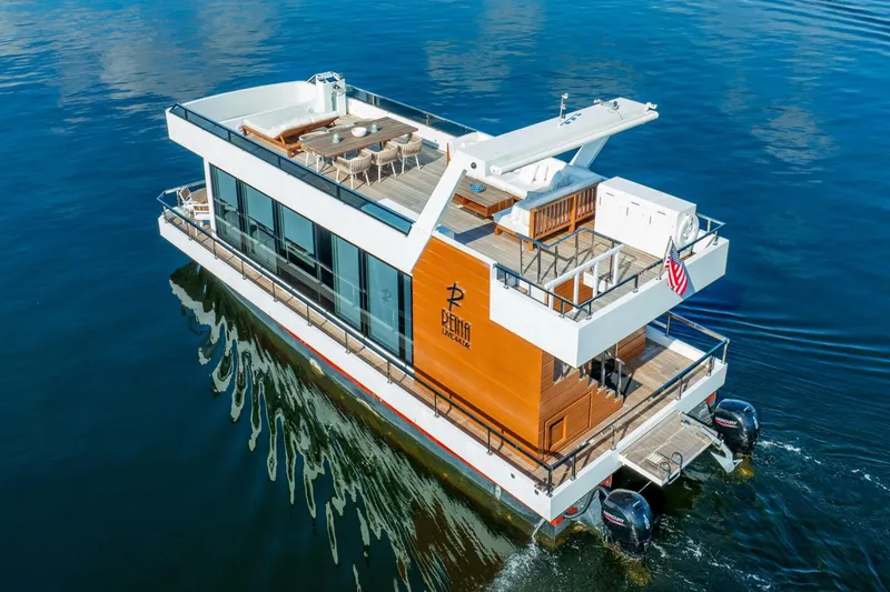 Slide: The Image of Luxury 2024 Reina L44 DR yacht cruising on calm waters, featuring modern design and spacious deck. - 5