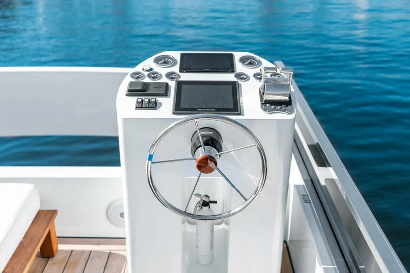 Slide: The Image of 2024 Reina L44 DR boat helm with modern controls and steering wheel. - 9