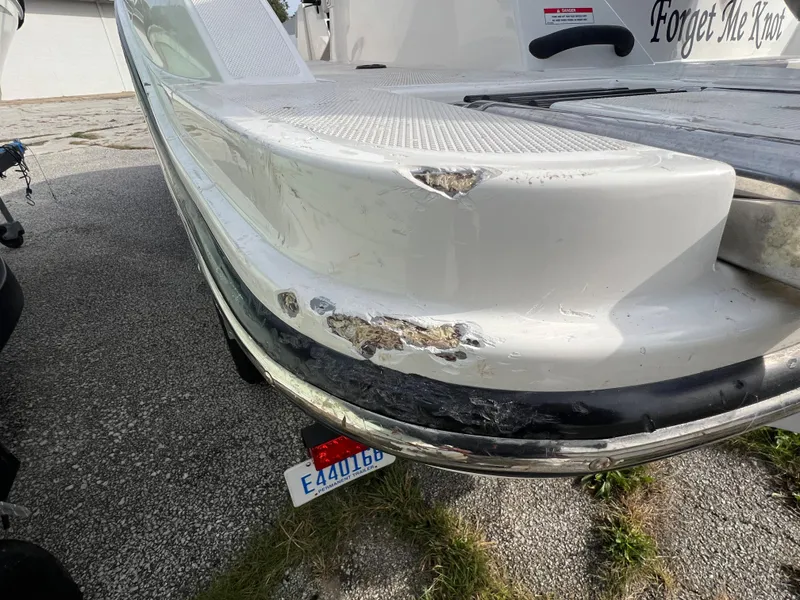 Slide: The Image of Damaged 2021 Sea Ray SPO 210 boat with visible hull scratches and dents. - 10