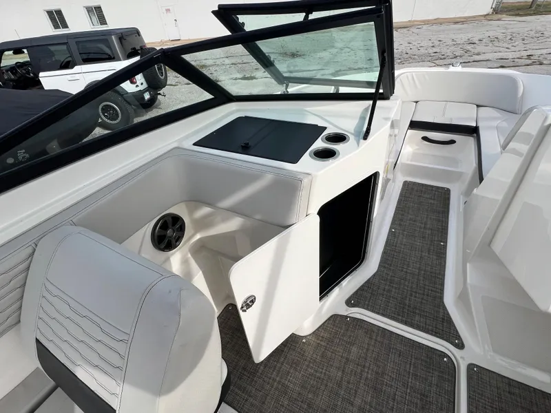 Slide: The Image of 2021 Sea Ray SPO 210 boat interior with seating and storage compartments. - 5