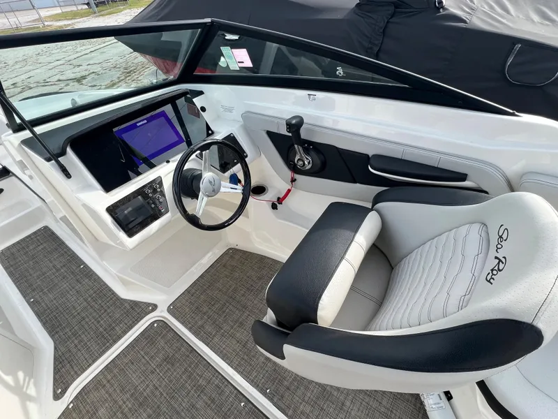 Slide: The Image of 2021 Sea Ray SPO 210 boat interior with steering wheel and control panel. - 6
