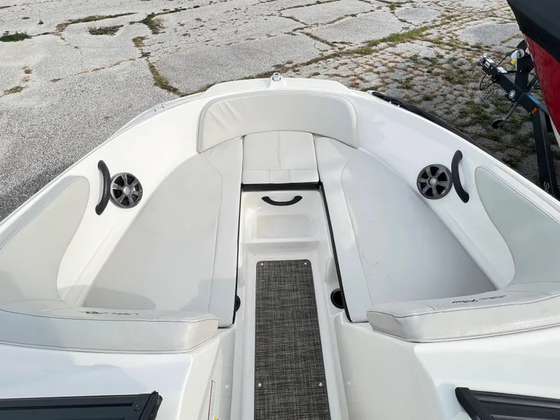 Slide: The Image of 2021 Sea Ray SPO 210 boat interior with white seating and speakers. - 9