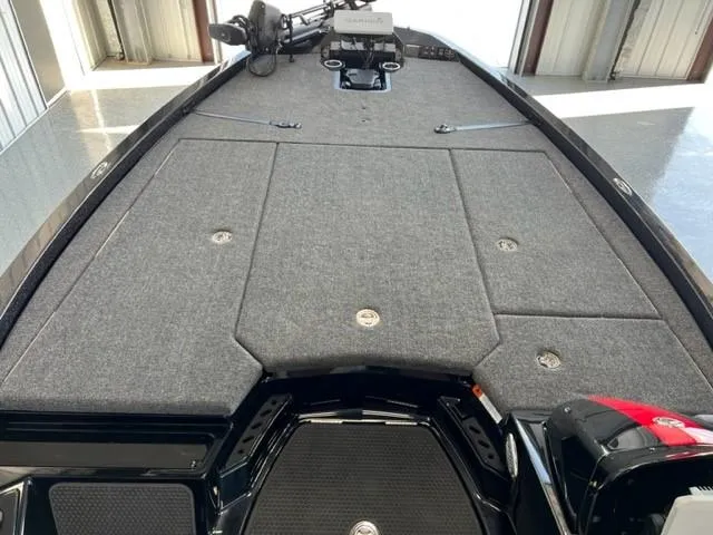 Slide: The Image of 2024 iKon LX21 boat deck with gray carpet and storage compartments. - 10