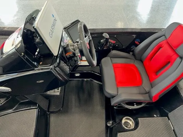 Slide: The Image of iKon LX21 2024 boat cockpit with Garmin navigation system and red-black captain's seat. - 13