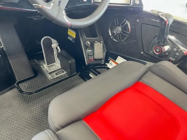 Slide: The Image of 2024 iKon LX21 boat interior with steering wheel, throttle, and red-black seat. - 14