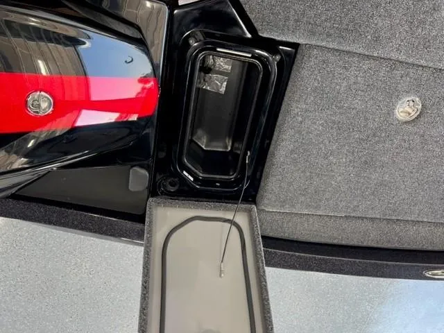 Slide: The Image of 2024 iKon LX21 boat storage compartment with black and gray interior. - 16