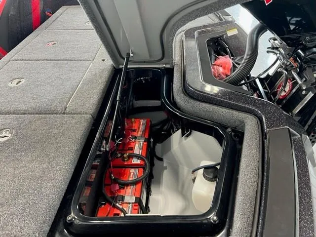 Slide: The Image of 2024 iKon LX21 boat battery compartment with red batteries and wiring. - 25